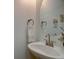 Stylish powder room features a modern sink, vanity, and decorative mirror at 18997 E 51St Pl, Denver, CO 80249