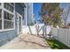 Cozy back patio with white picket fence offering privacy and outdoor space at 8199 Welby Rd # 501A, Denver, CO 80229