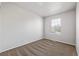 This bedroom features neutral carpet, white walls, and a single window at 8199 Welby Rd # 501A, Denver, CO 80229