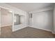 This bedroom features carpet, shelving, and an open doorway at 8199 Welby Rd # 501A, Denver, CO 80229