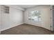 This bedroom features carpet, shelving, window, and an open doorway at 8199 Welby Rd # 501A, Denver, CO 80229