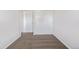 This bedroom features neutral carpet, white walls, and a closet with sliding doors at 8199 Welby Rd # 501A, Denver, CO 80229