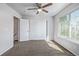 This bedroom features carpet, a window, a ceiling fan, and closet with sliding doors at 8199 Welby Rd # 501A, Denver, CO 80229