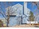 Side exterior view of the home featuring appealing blue siding at 8199 Welby Rd # 501A, Denver, CO 80229