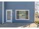 Blue house exterior with white door and window frames providing natural light at 8199 Welby Rd # 501A, Denver, CO 80229