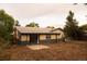 Spacious backyard with a sliding glass door leading to a patio, offering a blank canvas for outdoor activities and landscaping at 6213 Gray St, Arvada, CO 80003