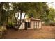 Backyard featuring sheds, greenery, and ample space, perfect for outdoor storage and potential landscaping projects at 6213 Gray St, Arvada, CO 80003