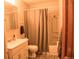 Neutral-toned bathroom including vanity, toilet and a bathtub with a shower curtain at 6213 Gray St, Arvada, CO 80003