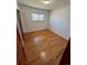 Bedroom featuring hardwood floors, neutral walls, and bright natural light at 6213 Gray St, Arvada, CO 80003