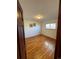 Bedroom with hardwood floors, natural light, and neutral-painted walls at 6213 Gray St, Arvada, CO 80003