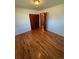 Bedroom features hardwood floors, closet, and open door to bathroom at 6213 Gray St, Arvada, CO 80003