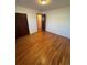 Bright bedroom features hardwood floors, closet, and neutral paint at 6213 Gray St, Arvada, CO 80003