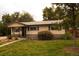 Charming single-story home with a well-maintained lawn and mature trees at 6213 Gray St, Arvada, CO 80003