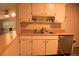 Bright kitchen with a dishwasher and bar seating at 6213 Gray St, Arvada, CO 80003