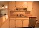 Kitchen featuring a stainless steel dishwasher, wood countertops and white cabinets at 6213 Gray St, Arvada, CO 80003