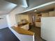 Bright kitchen featuring white cabinets, stainless steel dishwasher and a breakfast bar at 6213 Gray St, Arvada, CO 80003