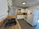 Cozy kitchen featuring wooden countertops and white cabinets at 6213 Gray St, Arvada, CO 80003