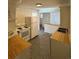 Cozy kitchen featuring white appliances, tiled floors, and wooden countertops at 6213 Gray St, Arvada, CO 80003