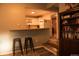 View of the kitchen from a living area featuring white appliances, wood countertop, and a breakfast bar at 6213 Gray St, Arvada, CO 80003