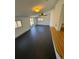 Bright living room featuring a sliding glass door, ceiling fan, and sleek flooring at 6213 Gray St, Arvada, CO 80003