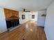 Spacious living room featuring a wood-paneled fireplace and hardwood floors at 6213 Gray St, Arvada, CO 80003