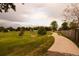 Scenic view of a neighborhood walking path surrounded by lush greenery, perfect for a relaxing stroll or active recreation at 6213 Gray St, Arvada, CO 80003