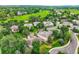 An aerial view of the neighborhood, golf course, and landscaping surrounding a single Gathering home at 11070 Meade Ct, Westminster, CO 80031