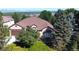 An aerial view showcases this beautiful home with lush surroundings, trees, and mountain views in the distance at 11070 Meade Ct, Westminster, CO 80031