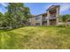 The back of a beautiful home showing the expansive backyard with lush grass and a balcony at 11070 Meade Ct, Westminster, CO 80031