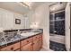 Traditional bathroom with a single sink vanity and black marble countertops with a shower and bath combination at 11070 Meade Ct, Westminster, CO 80031