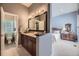 Stylish bathroom features a double vanity with granite counters, dark wood cabinets, and a separate toilet area at 11070 Meade Ct, Westminster, CO 80031