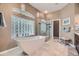 Bright bathroom featuring a modern soaking tub, walk-in shower, and unique glass block window at 11070 Meade Ct, Westminster, CO 80031