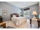Bright bedroom with large window, neutral walls, and a queen bed, creating a relaxing atmosphere at 11070 Meade Ct, Westminster, CO 80031