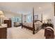 Inviting bedroom with a four-poster bed, soft lighting, and a sitting area for relaxation at 11070 Meade Ct, Westminster, CO 80031