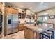 Gourmet kitchen with granite countertops, stainless steel appliances, a center island, and custom cabinetry at 11070 Meade Ct, Westminster, CO 80031