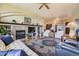 Comfortable living room with a stone fireplace, hardwood floors, and an open layout create a cozy ambiance at 11070 Meade Ct, Westminster, CO 80031