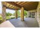 Covered patio supported by stone pillars, showcasing outdoor living space and views of the landscaped yard and neighborhood at 11070 Meade Ct, Westminster, CO 80031