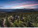 Expansive estate nestled among the trees, with scenic mountain views at sunset at 28800 Stonecrop Trl, Conifer, CO 80433