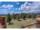 Stone patio with iron railing and stunning mountain views at 28800 Stonecrop Trl, Conifer, CO 80433