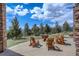 Outdoor patio area with seating and a fire pit, perfect for enjoying the surrounding nature at 28800 Stonecrop Trl, Conifer, CO 80433