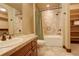 Neutral bathroom featuring a tub with tile surround and built-in shelving at 28800 Stonecrop Trl, Conifer, CO 80433