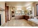 Elegant bathroom features double vanity, soaking tub, tile flooring, and a bright, open design at 28800 Stonecrop Trl, Conifer, CO 80433
