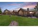 Beautiful house with stone and stucco exterior, set on a manicured lawn at 28800 Stonecrop Trl, Conifer, CO 80433