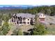 Stunning view of a luxury home with decks and manicured landscaping at 28800 Stonecrop Trl, Conifer, CO 80433