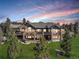 Large home exterior featuring a patio with lush backyard at 28800 Stonecrop Trl, Conifer, CO 80433