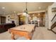 Entertain in this game room with a pool table, stone fireplace, and kitchenette at 28800 Stonecrop Trl, Conifer, CO 80433