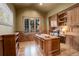 A stately home office with custom wood paneling and built-in shelving at 28800 Stonecrop Trl, Conifer, CO 80433