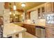 Kitchenette with granite countertops, tile backsplash, stainless steel appliances and great lighting at 28800 Stonecrop Trl, Conifer, CO 80433