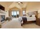 Spacious main bedroom with high ceilings, fireplace, and access to balcony at 28800 Stonecrop Trl, Conifer, CO 80433