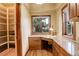 Cozy office nook with scenic views, built-in drawers, and granite countertop at 28800 Stonecrop Trl, Conifer, CO 80433